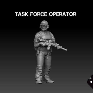 May include: A grey plastic miniature figurine of a military operator holding a rifle. The figurine is wearing a helmet, tactical vest, and trousers. The text "TASK FORCE OPERATOR" is displayed above the figurine.
