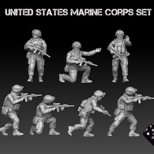 May include: A set of seven grey plastic figurines depicting United States Marines in various combat poses. The Marines are holding rifles and wearing tactical gear. The figurines are part of a set called "United States Marine Corps Set" by Black Hills Games.