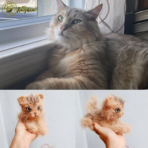 May include: A close-up of two crocheted cat toys. The first toy is a light brown tabby cat with a white chest and a white spot on its forehead. The second toy is a light brown tabby cat with a white chest and a white spot on its forehead. Both toys are sitting on a person's hand.