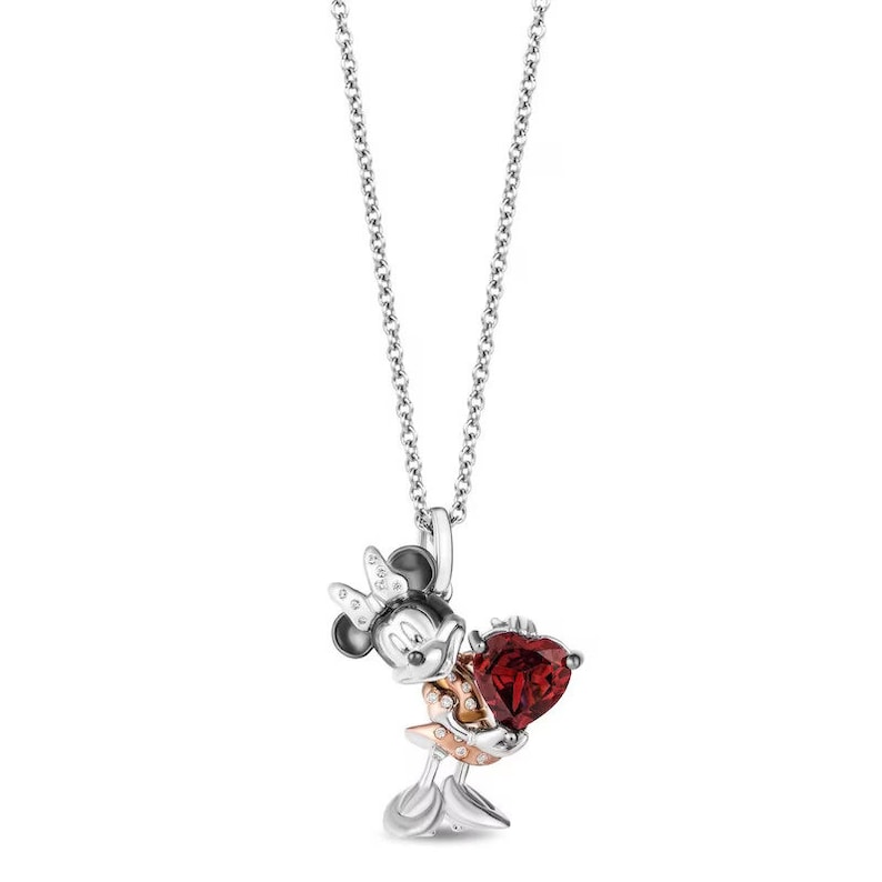May include: Silver necklace with a pendant featuring Minnie Mouse holding a red heart-shaped crystal. The pendant is accented with smaller clear crystals.