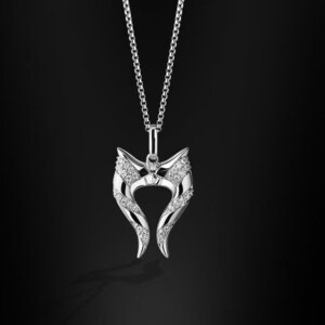 May include: A silver necklace with a pendant shaped like two horns with a diamond-like design. The pendant is adorned with small, clear stones.