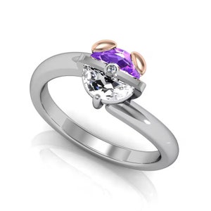 May include: A silver ring with a purple and white gemstone setting. The ring has a rose gold accent on the sides.