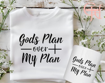May include: White sweatshirt and mug with the text "God's Plan over My Plan" in black lettering.