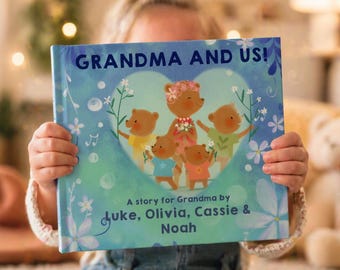 May include: A hardcover children's book titled GRANDMA AND US! A story for Grandma by Luke, Olivia, Cassie & Noah. The cover features a large heart shape containing five illustrated bears in blue, yellow, and orange, surrounded by blue flowers.