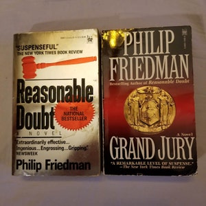 May include: Two paperback books by Philip Friedman. The book on the left is titled "Reasonable Doubt" with a gavel graphic and the words "The National Bestseller." The book on the right is titled "Grand Jury."