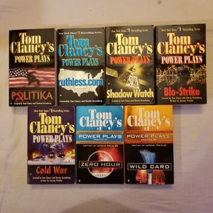 May include: A collection of Tom Clancy's "Power Plays" books. The book covers feature titles like "Politika", "Ruthless.com", "Shadow Watch", "Bio-Strike", "Cold War", "Zero Hour", and "Wild Card". The series is labeled as a New York Times #1 Bestselling Series.