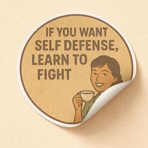 May include: A round sticker with a retro design. The sticker features the text "IF YOU WANT SELF DEFENSE, LEARN TO FIGHT" in brown letters. A smiling woman holding a cup of coffee is also depicted.