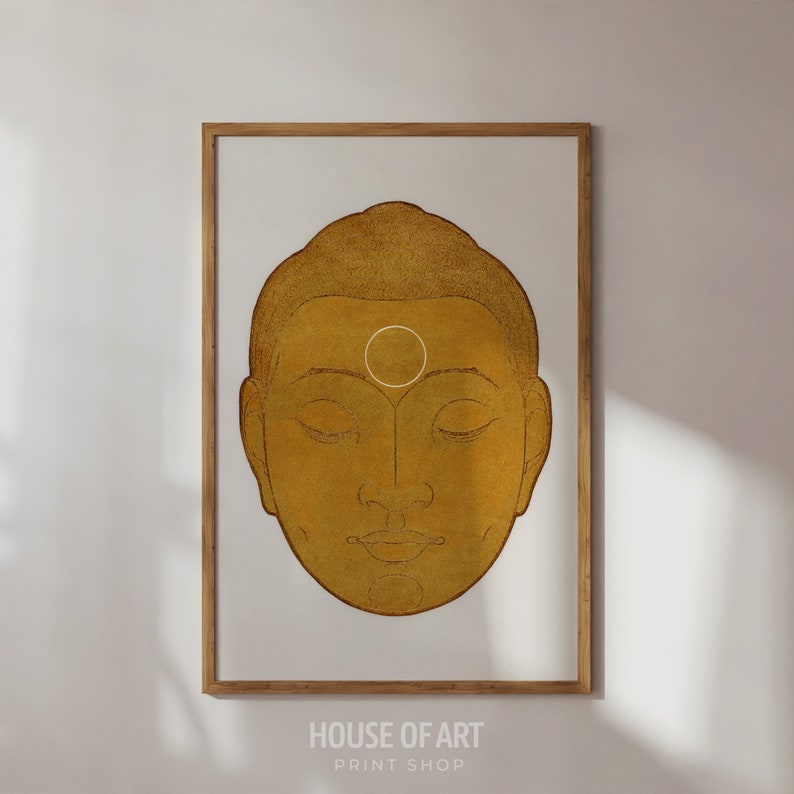 May include: A gold-colored illustration of a Buddha's face with closed eyes. The illustration has a white circle on the forehead.