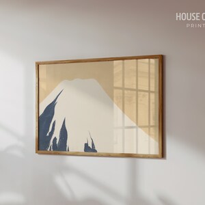 May include: A framed print of a minimalist mountain landscape in shades of beige, white, and blue. The print is titled "HOUSE OF ART PRINT SHOP".