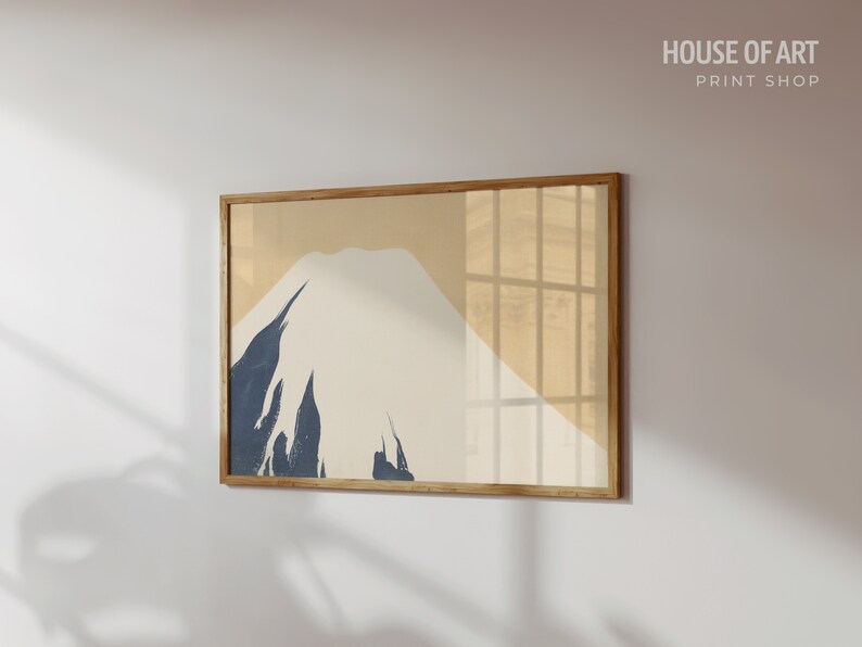 May include: A framed print of a minimalist mountain landscape in shades of beige, white, and blue. The print is titled "HOUSE OF ART PRINT SHOP".