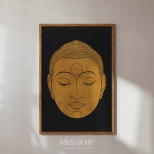May include: A gold Buddha face with closed eyes and a third eye on the forehead, on a black background.