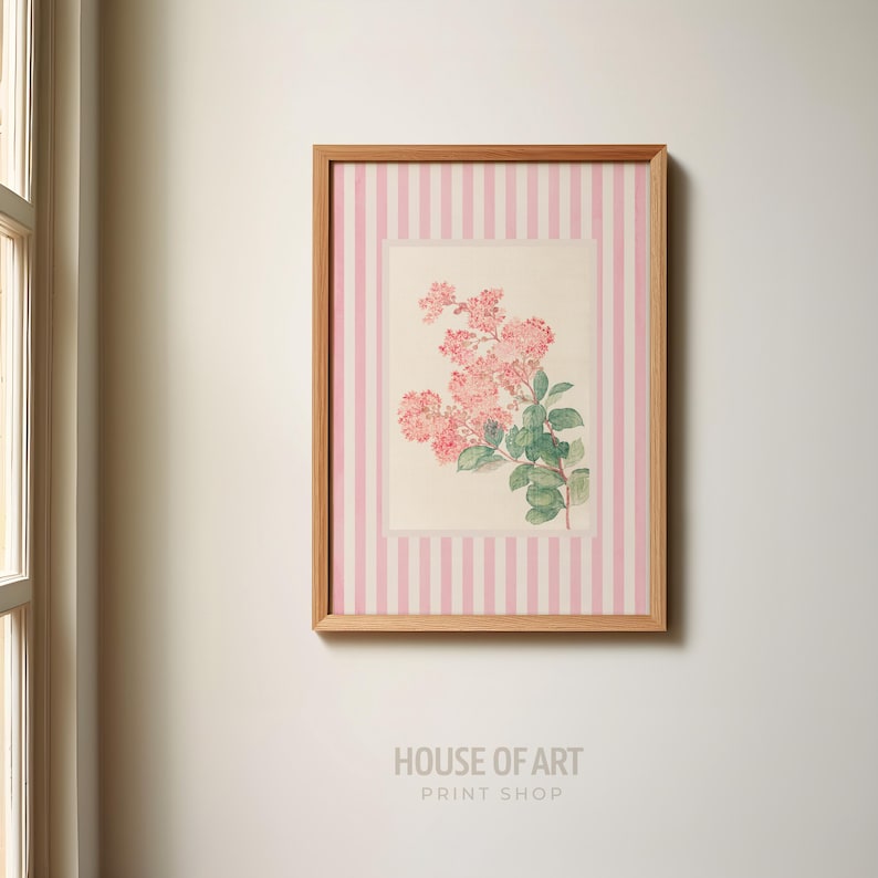 May include: A framed floral print featuring pink flowers and green leaves. The artwork is set against a pink and white striped background, encased in a wooden frame. The text "HOUSE OF ART PRINT SHOP" is at the bottom.