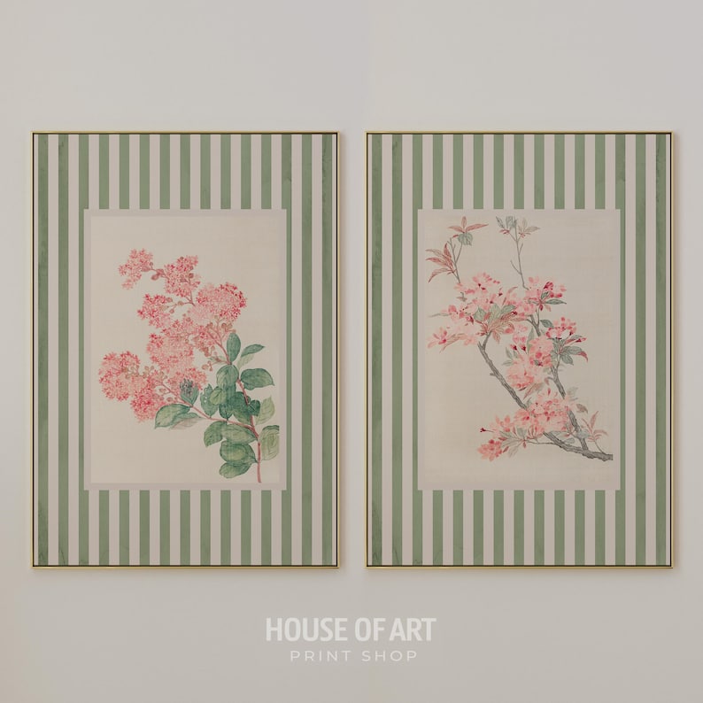 May include: Two framed floral prints. Each print features a botanical illustration of pink flowers and green leaves. The frames have a gold border and are set against a background of vertical green and white stripes. The text "HOUSE OF ART PRINT SHOP" is at the bottom.