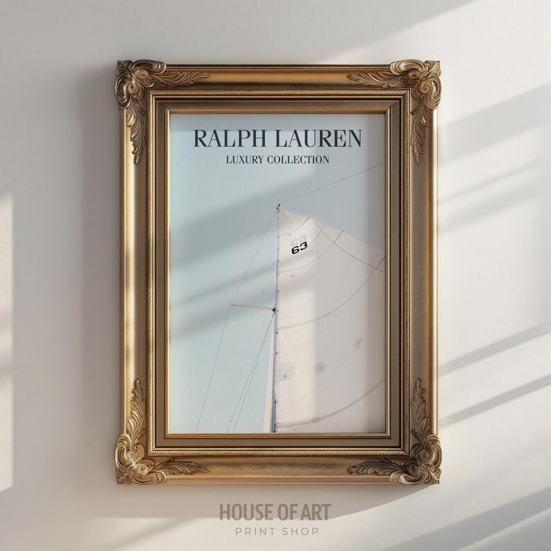 May include: A framed print featuring a sailboat with the text "RALPH LAUREN LUXURY COLLECTION". The frame is gold-colored with ornate detailing. The print also includes the number "63" on the sail. The words "HOUSE OF ART PRINT SHOP" are at the bottom.