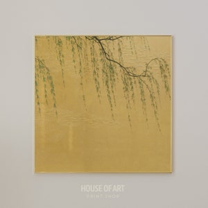 May include: A painting of a willow tree branch with green leaves hanging over a gold background. The painting is framed in a thin gold frame.