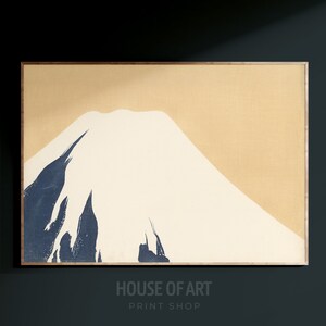 May include: A minimalist print of Mount Fuji in blue and white on a beige background. The print is framed in a light wood frame.