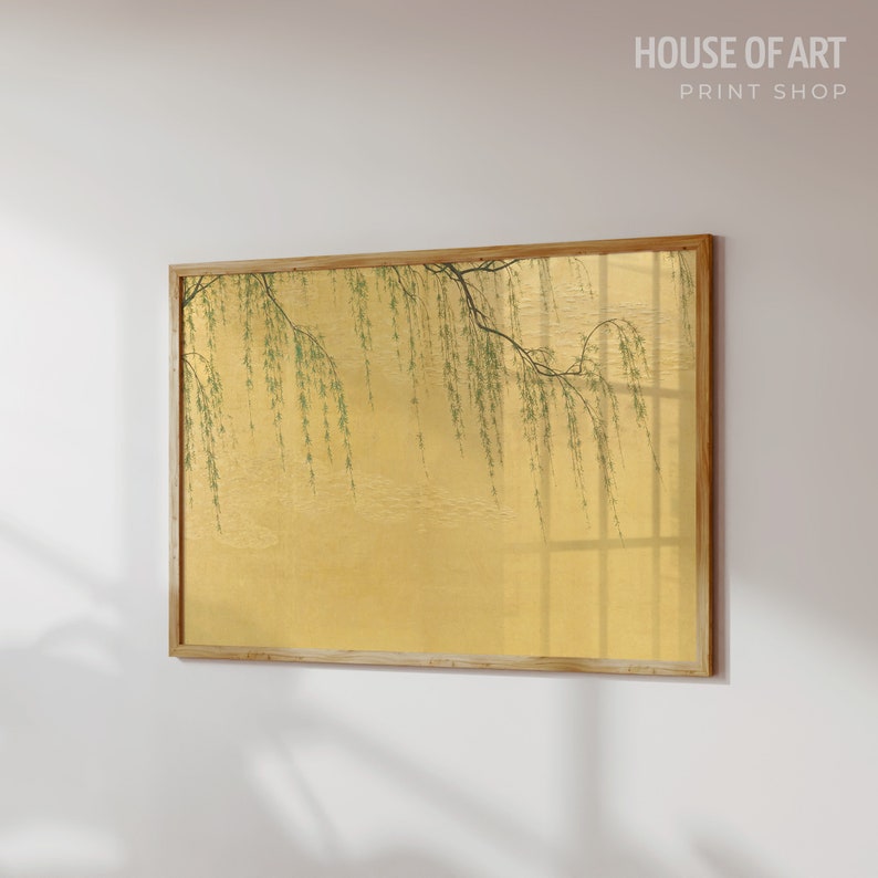 May include: A framed print of a willow tree branch with green leaves hanging over a golden background. The print is in a wooden frame.