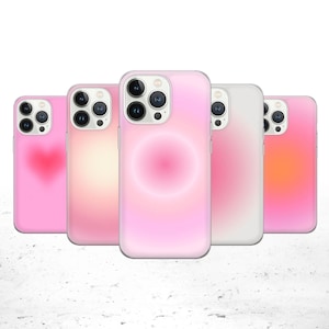 May include: Five different phone cases with pink, white, and orange gradient designs. The cases have a clear back and a raised camera bump.
