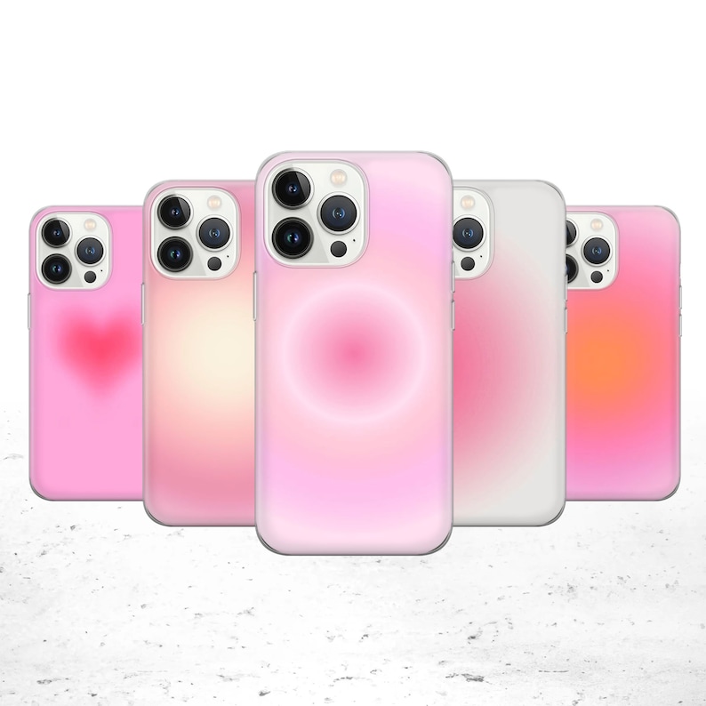May include: Five different phone cases with pink, white, and orange gradient designs. The cases have a clear back and a raised camera bump.
