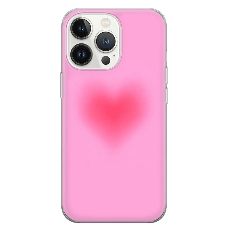 May include: A pink phone case with a clear back and a red heart design.