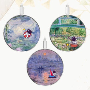 Cargador móvil Monet de 15 W con carga inalámbrica y diseño de astronauta de dibujos animados - Compatible con Qi para Apple iPhone, Google Pixel y Samsung