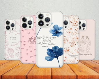 May include: Five different phone cases with various designs. The cases are white with different floral patterns and inspirational quotes. The quotes include "When the time is right, I the Lord, will make it happen. Isaiah 60:22" and "There is no fear in love".