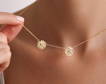 May include: A gold necklace with two delicate flower pendants, each featuring a small sparkling stone in the center.