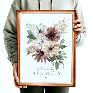 May include: A framed watercolor print with a bouquet of flowers in shades of brown, white, and green. The text "Kort er vår dag, det kvelder. Akk. så fort!" is printed below the flowers.