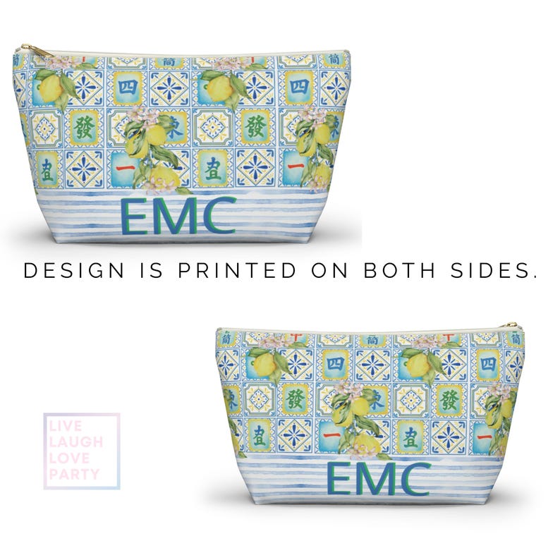 May include: Two cosmetic bags with a lemon and floral tile pattern. The bags have a blue and white striped base with the letters "EMC" in blue. The text "DESIGN IS PRINTED ON BOTH SIDES" is also visible.