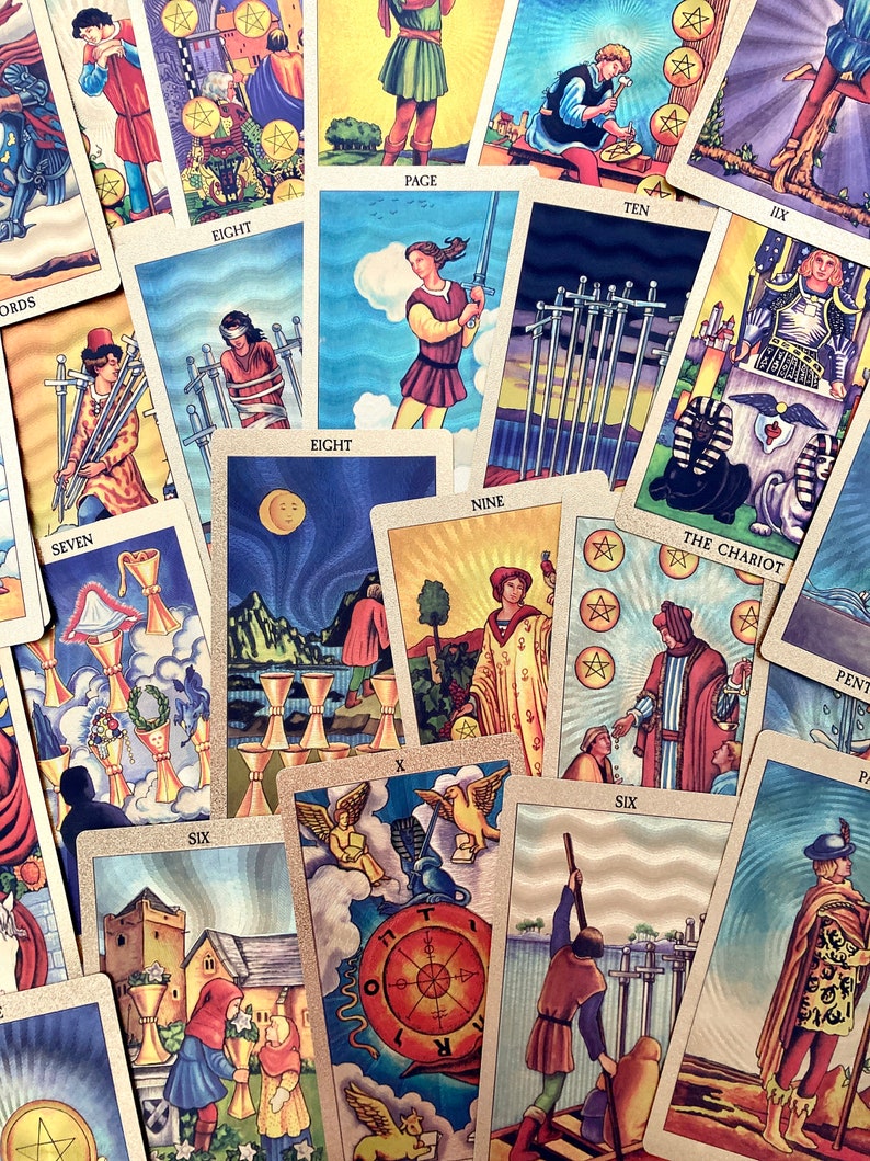 May include: A spread of tarot cards with colorful illustrations and gold accents. The cards include the Eight of Swords, the Nine of Swords, the Ten of Swords, the Page of Swords, the Eight of Cups, the Six of Cups, the Chariot, the Wheel of Fortune, and the Six of Swords.