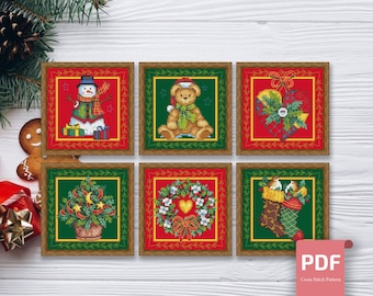 May include: Six cross stitch patterns featuring Christmas themes. The patterns include a snowman, a teddy bear, a heart, a wreath, a Christmas tree, and a stocking.