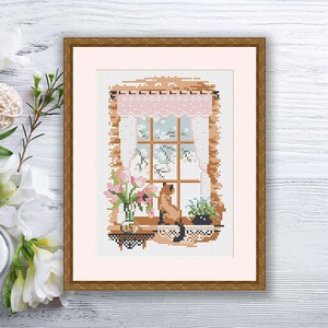 May include: A cross-stitch embroidery depicting a window with a cat sitting on the windowsill, looking out. There are flowers in a vase on the windowsill and a plant in a pot.