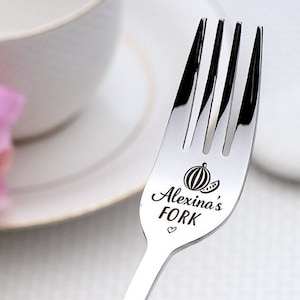 May include: A silver fork with the words "Alexina's Fork" engraved on it, along with a small heart and a watermelon graphic.