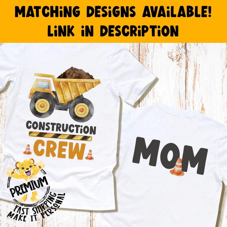 May include: A white t-shirt featuring a yellow dump truck graphic with the text CONSTRUCTION CREW and orange traffic cones. A second white t-shirt displays the word MOM in large black letters with an orange traffic cone graphic.