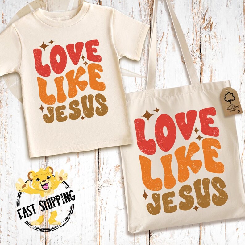 May include: A white tote bag and a white t-shirt with the text "LOVE LIKE JESUS" in a retro font with orange, red, and brown colors. The text is stylized with a distressed look.