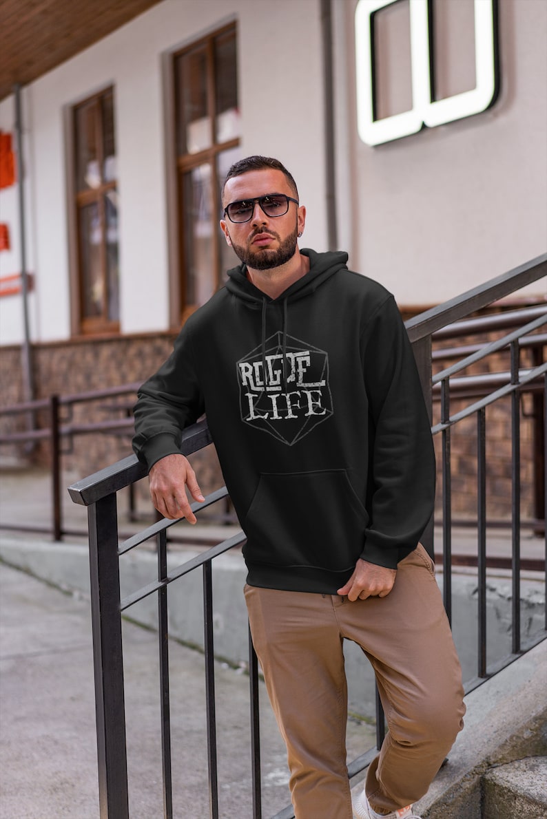 May include: A black hooded sweatshirt with a white graphic of a dice with the text "ROGUE LIFE" on it.