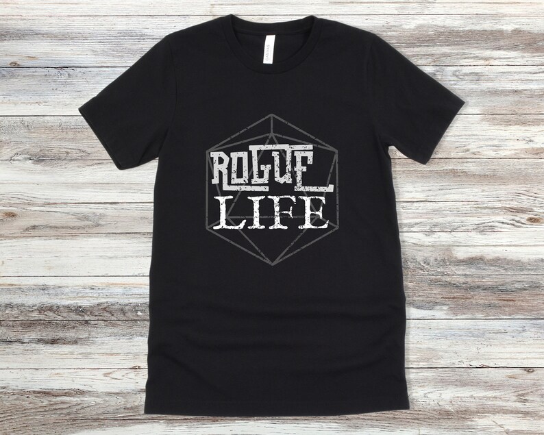 May include: Black t-shirt with a white graphic of a dice with the text "Rogue Life" inside.