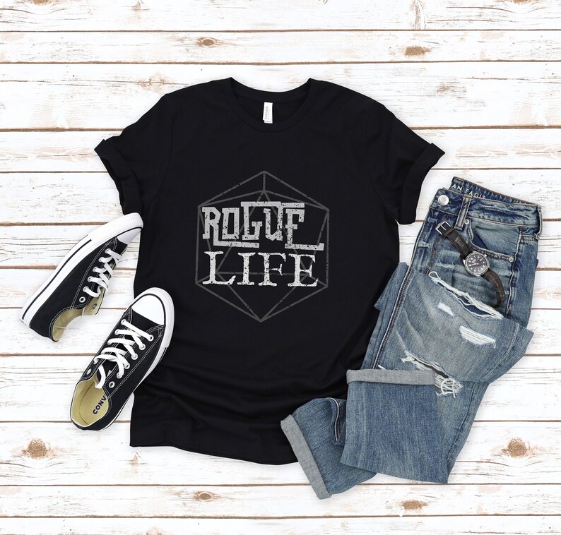 May include: Black t-shirt with a white graphic of a 20-sided die with the text "Rogue Life" inside.