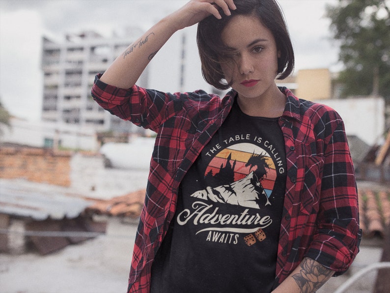 The table is calling adventure awaits dnd t-shirt design on a trendy young woman with in the city