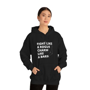 May include: Black hooded sweatshirt with a white graphic that says "Fight like a rogue, charm like a bard." A 20-sided die is incorporated into the graphic.