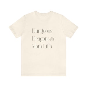 May include: A white t-shirt with the text "Dungeons Dragons Mom Life" and a Dungeons and Dragons dice symbol.