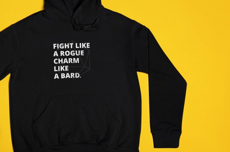 May include: Black hoodie with a white graphic that says "Fight like a rogue, charm like a bard." The graphic also includes a stylized image of a 20-sided die.