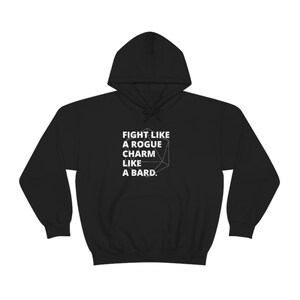 May include: Black hooded sweatshirt with white text that reads "Fight like a rogue, charm like a bard." A white outline of a twenty-sided die is in the centre of the text.
