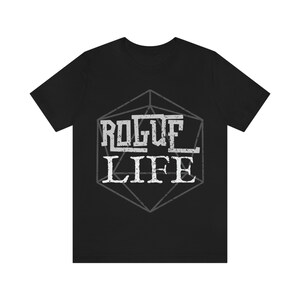 May include: Black t-shirt with a white graphic of a 20-sided die with the text "ROGUE LIFE" inside.