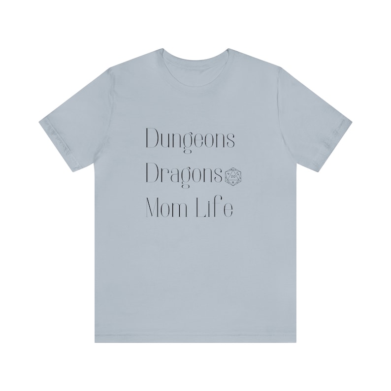 May include: Light blue t-shirt with the text "Dungeons & Dragons Mom Life" and a Dungeons & Dragons dice symbol.