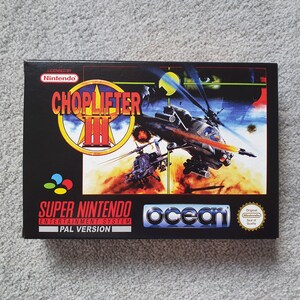 May include: A black Super Nintendo game box for Choplifter III. The box art shows a helicopter in flight over a fiery landscape. The game title is in a yellow and red design. The Ocean and Nintendo logos are also visible.