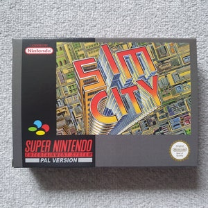May include: A Super Nintendo Entertainment System game cartridge for SimCity, a city-building simulation game. The box is grey with a colourful image of a city skyline and the game title in large, bold letters. The box also includes the Nintendo logo and the text "PAL Version".