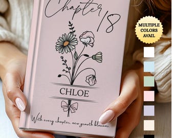 May include: A pink journal with the text "Chapter 18" in cursive, floral illustrations, and the name "Chloe." The cover also includes the phrase "With every chapter, new growth blossoms." A gold sticker indicates multiple colors are available.