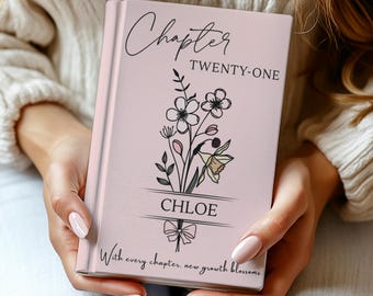 May include: A pink book with the words "Chapter TWENTY-ONE" and "CHLOE" in script. Floral illustrations and the phrase "With every chapter, new growth blossoms" are also featured on the cover.