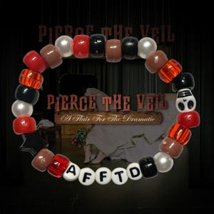 May include: A colourful beaded bracelet featuring red, black, brown, and white beads. The bracelet spells out "AFFTD" with letter beads. The background includes the text "Pierce the Veil" and "A Flair For The Dramatic".